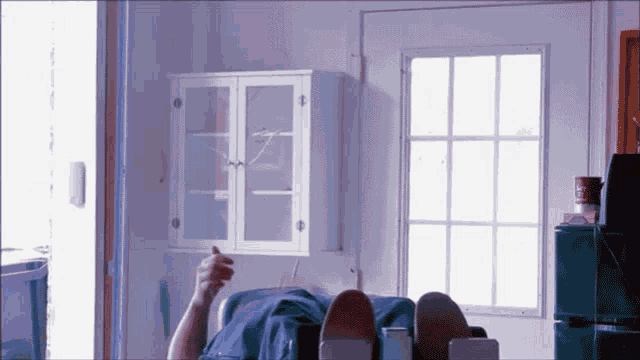 a person laying on a couch with their feet up