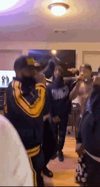 a group of people are standing in a living room .