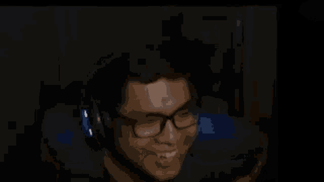 a man wearing glasses and headphones with the words " aduh lulut aing kopong goblok " on the bottom