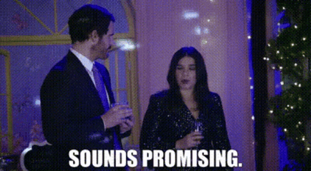 a man and a woman are standing next to each other in a room .