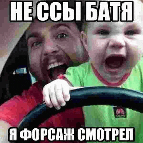 a man is driving a car while holding a crying baby in his lap .