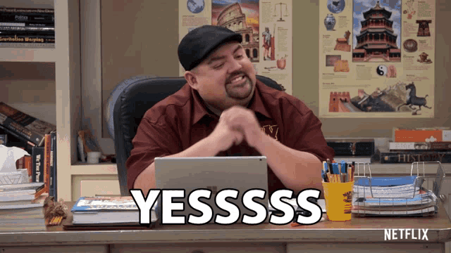 a man sitting at a desk with a netflix sign on the desk