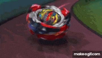 a close up of a red , yellow , and blue toy spinning on a table .