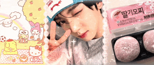 a boy wearing a hello kitty hat is next to a box of rice cakes