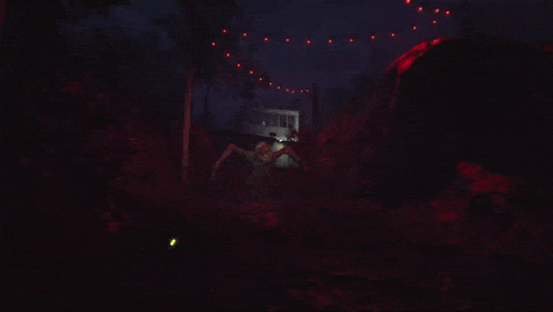 a giant spider is crawling through a dark forest at night