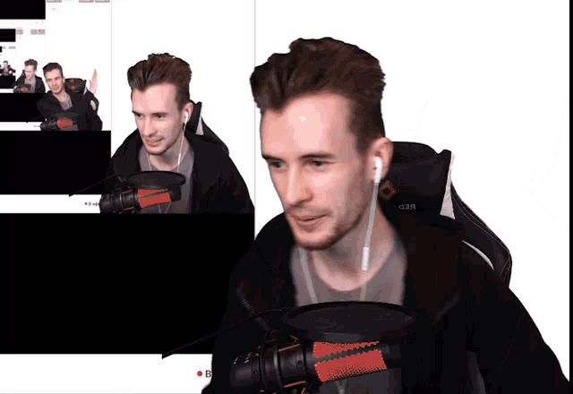a man sitting in front of a microphone with the word e on the bottom right