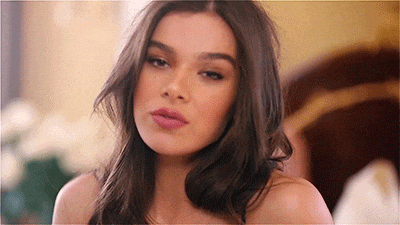 a close up of a woman 's face with long hair and a pink lip .