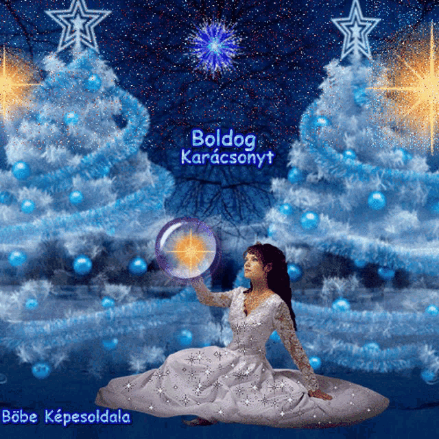 a woman in a white dress is sitting in front of a christmas tree with the words boldog karacsonyt written on the bottom