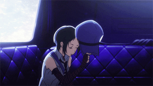 a girl is sitting on a couch holding a hat