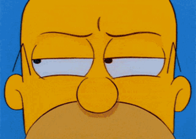 a close up of homer simpson 's face with an angry look on his face