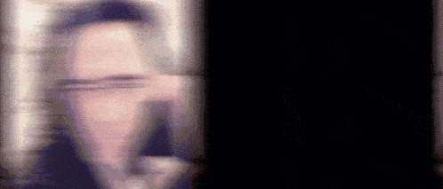 a blurry picture of a man 's face with a black background