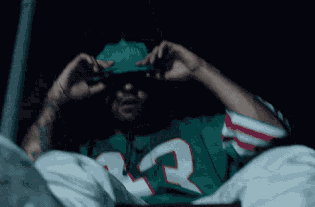 a man wearing a green and red jersey with the number 22 on it
