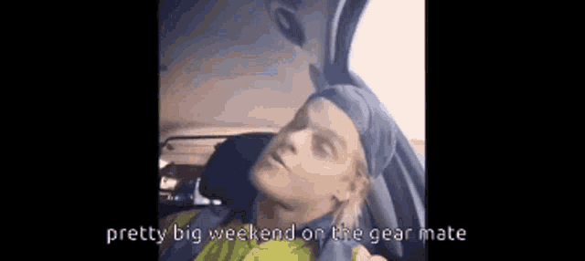 a man is sitting in the back of a car with his head in the trunk and says pretty big weekend on the gear mate