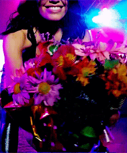 a woman holding a bouquet of flowers in her hand