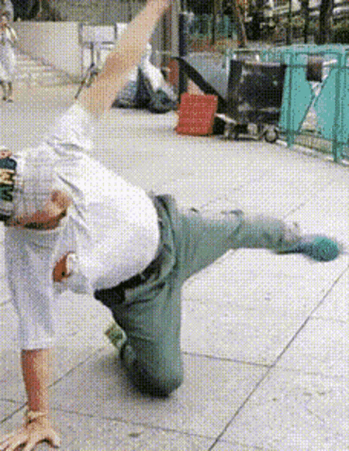 a man wearing a hat with the letter n on it is doing a yoga pose