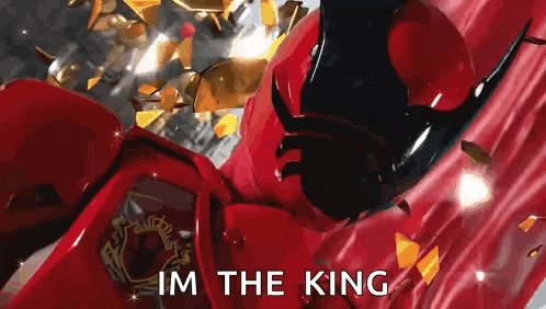 a red robot is flying through the air with the words `` i 'm the king '' written on it .