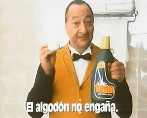 a man in a tuxedo is holding a bottle of detergent and a bottle of soap .