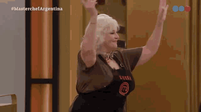 a woman wearing an apron that says luisa is dancing