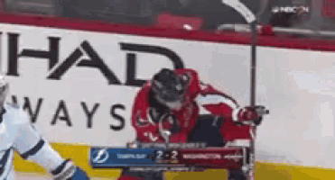 a hockey game is being played in front of a halo ad