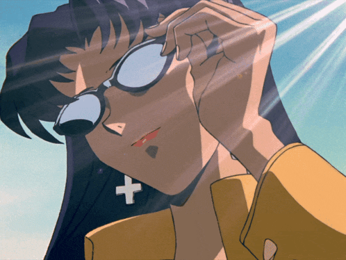 a woman wearing sunglasses has a cross earring
