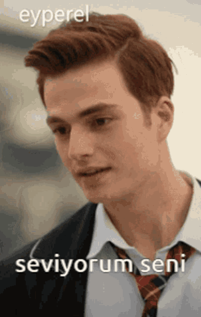 a young man with red hair is wearing a suit and tie with the words seviyorum seni below him
