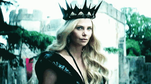 a woman is wearing a black crown and a black dress .
