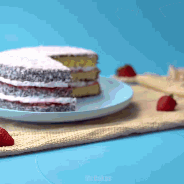 a cake with a slice taken out of it sits on a plate with strawberries