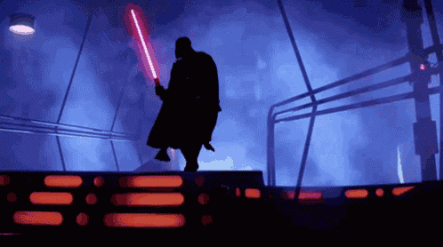 a silhouette of darth vader is holding a red light saber