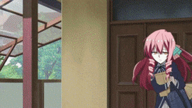 a girl with red hair is standing in front of a window