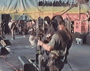 a man holding a camera in front of a crowd of people