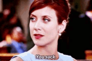 a woman in a blue dress is saying you suck .