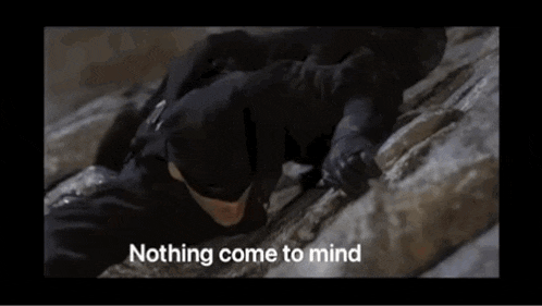 a man in a mask is crawling on a rock with the words " nothing come to mind " above him