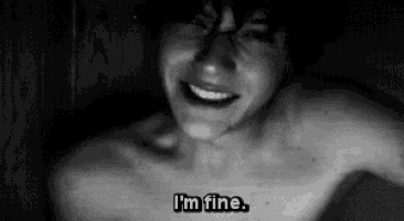 a black and white photo of a shirtless man with the words `` i 'm fine '' written on his chest .