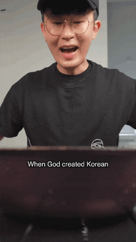 a man wearing glasses and a black shirt says when god created korean on the screen