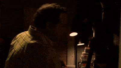 a close up of a man 's face in a dark room