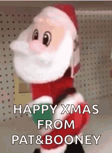 a stuffed santa claus is standing in front of a sign that says `` happy xmas from pat & boonery '' .
