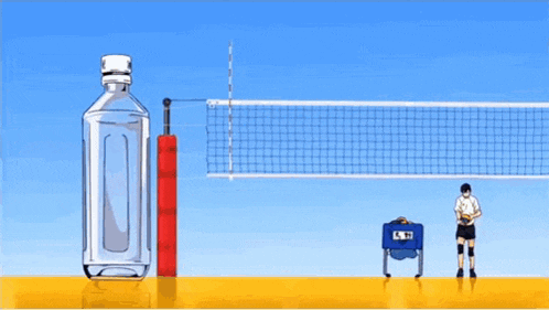 a volleyball is being thrown at a volleyball net with a bottle of water in the foreground
