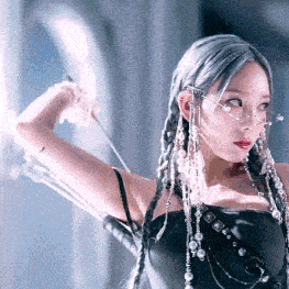 a woman in a black dress is holding a bow and arrow .