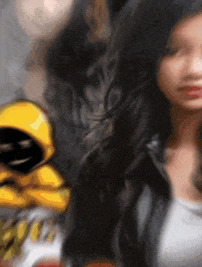 a blurry picture of a woman standing next to a cartoon character