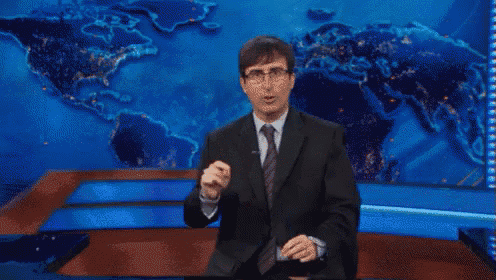 a man in a suit and tie is dancing in front of a world map .