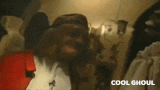 a man with a beard and a hat is smiling in a room with the word cool on the bottom