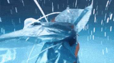 a person is standing in the water with a blue umbrella