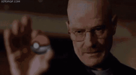 a man is holding a pokemon ball in his hand .