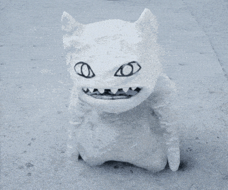 a white monster with black eyes and teeth is standing on a sidewalk