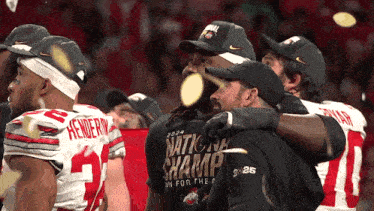 a group of football players wearing shirts that say national champs