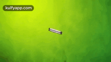 a green background with a white object on it .