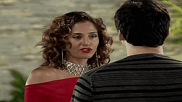 a man and a woman are looking at each other