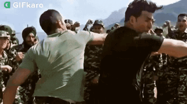 two men are standing next to each other in front of a group of soldiers .