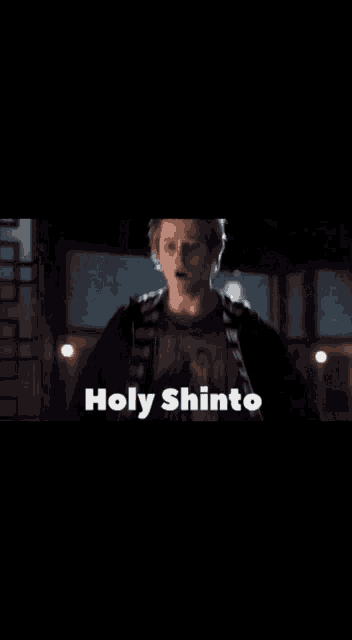 a man in a dark room with the words holy shinto on the bottom