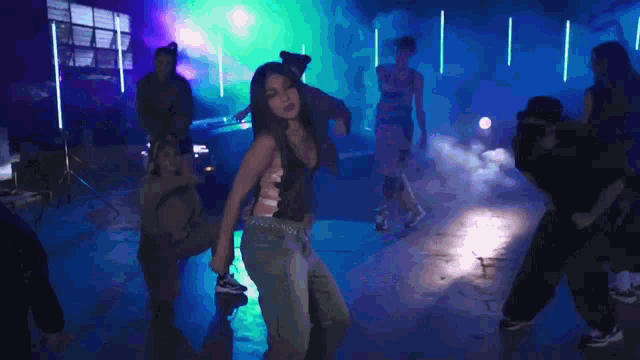 a blurry picture of a woman dancing in a club